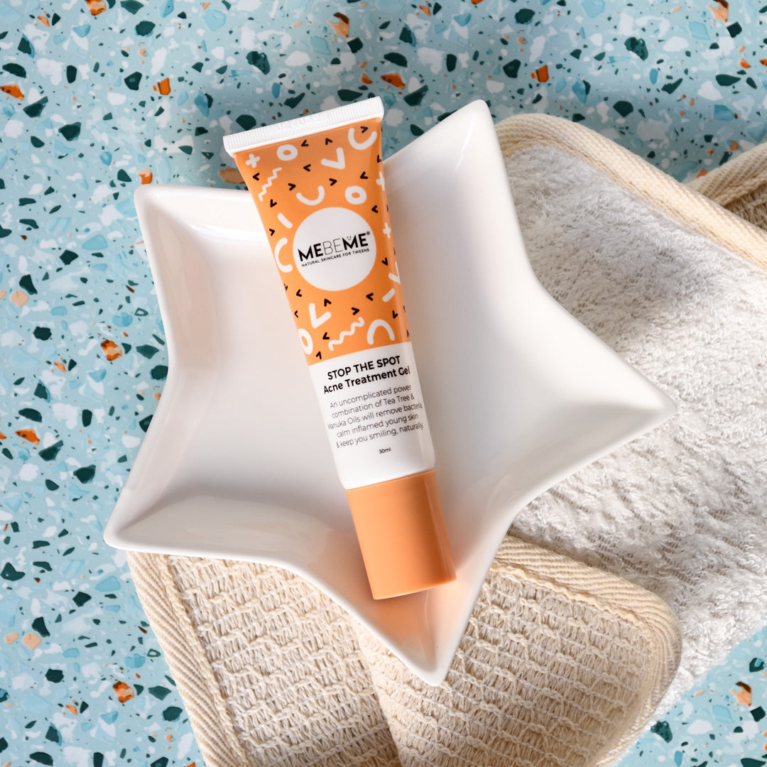 Stop the spot acne treatment gel on star plate with blue speckled background