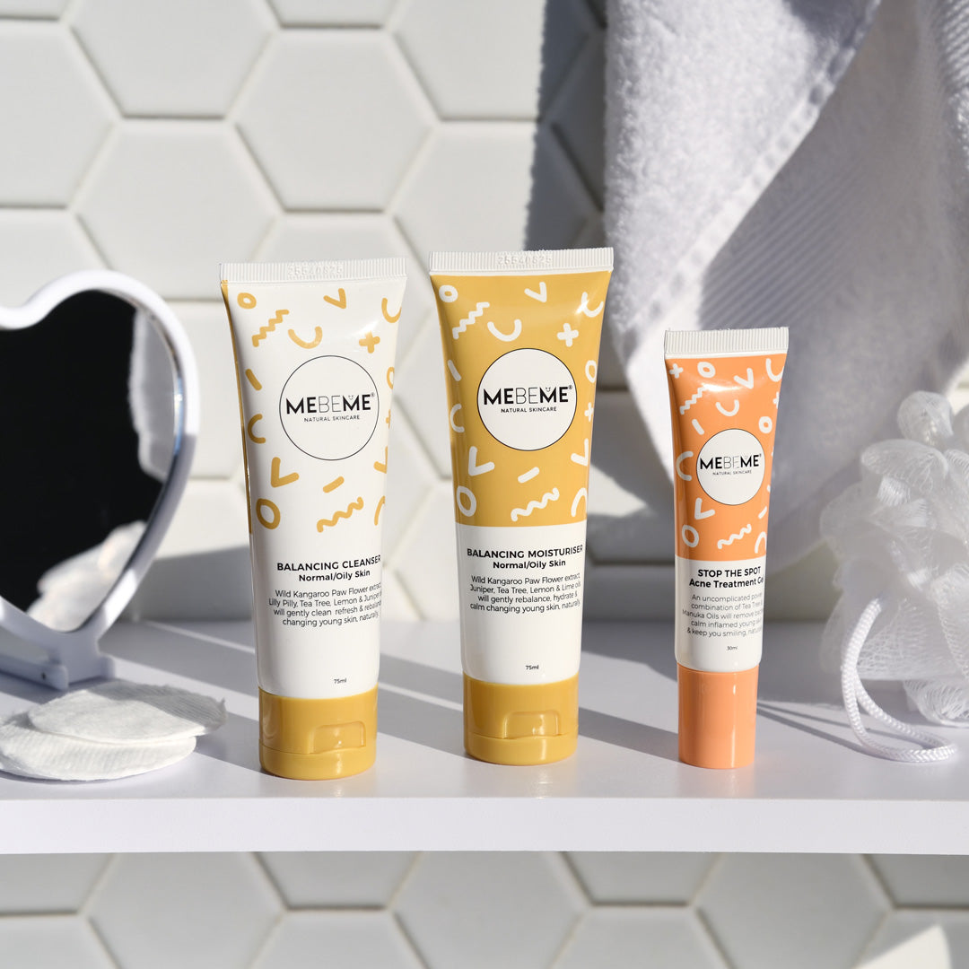 Three MEBEME skincare products on a bathroom shelf with a tiled wall background.