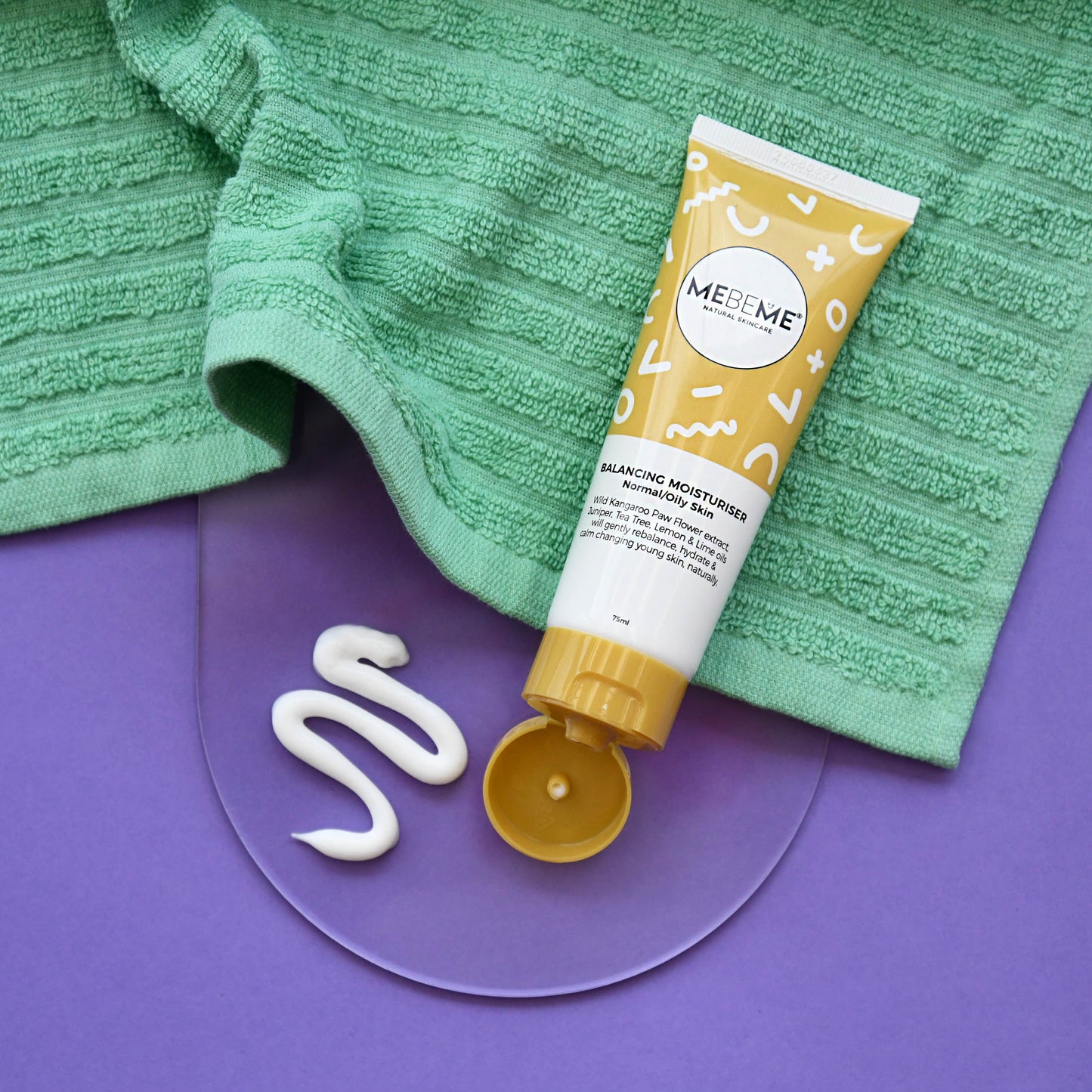 Tube of MEBEME skincare product on a green towel with a purple background
