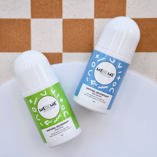 Two bottles of MEBEME natural deodorants on a checkered tablecloth.