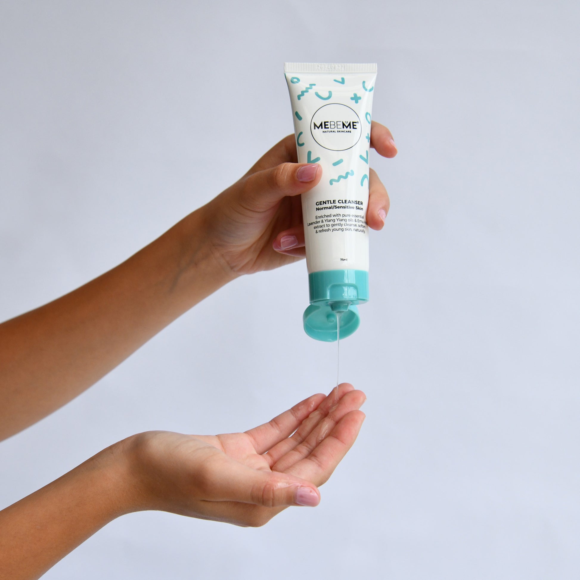 Hand holding a MEBEMEE skincare product with a white background