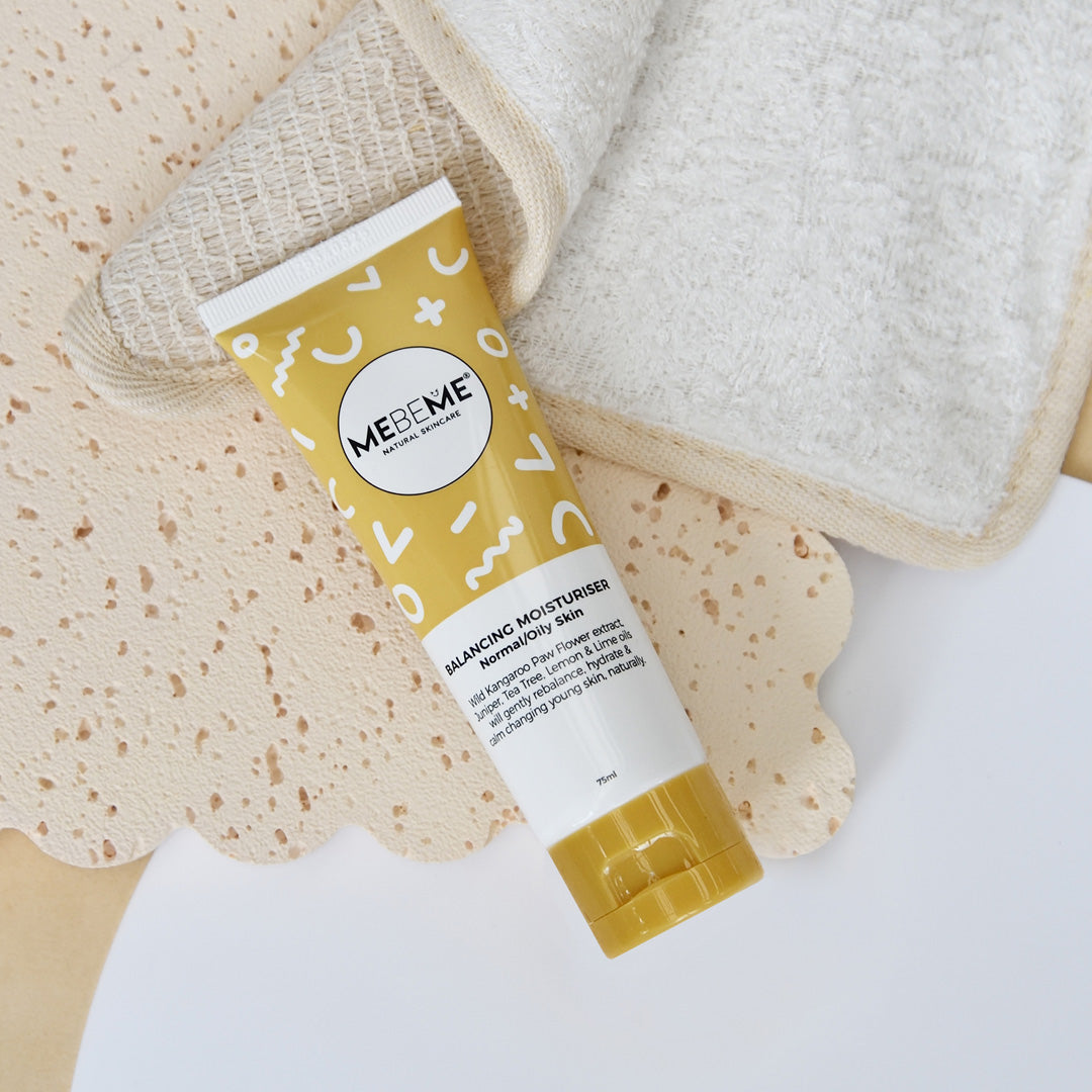 Tube of MEBEME skincare product with a textured towel and washcloth on a white background