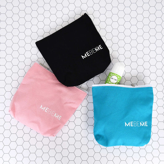 Three MEBEME bags in black, pink, and turquoise on a tiled surface