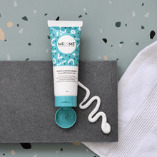 Load image into Gallery viewer, blue and white tube of gentle moisturiser for normal, sensitive and dry skin, with a blue lid. On a grey tile and green speckled background with a towel. A zig zag of moisturiser is squeezed out.