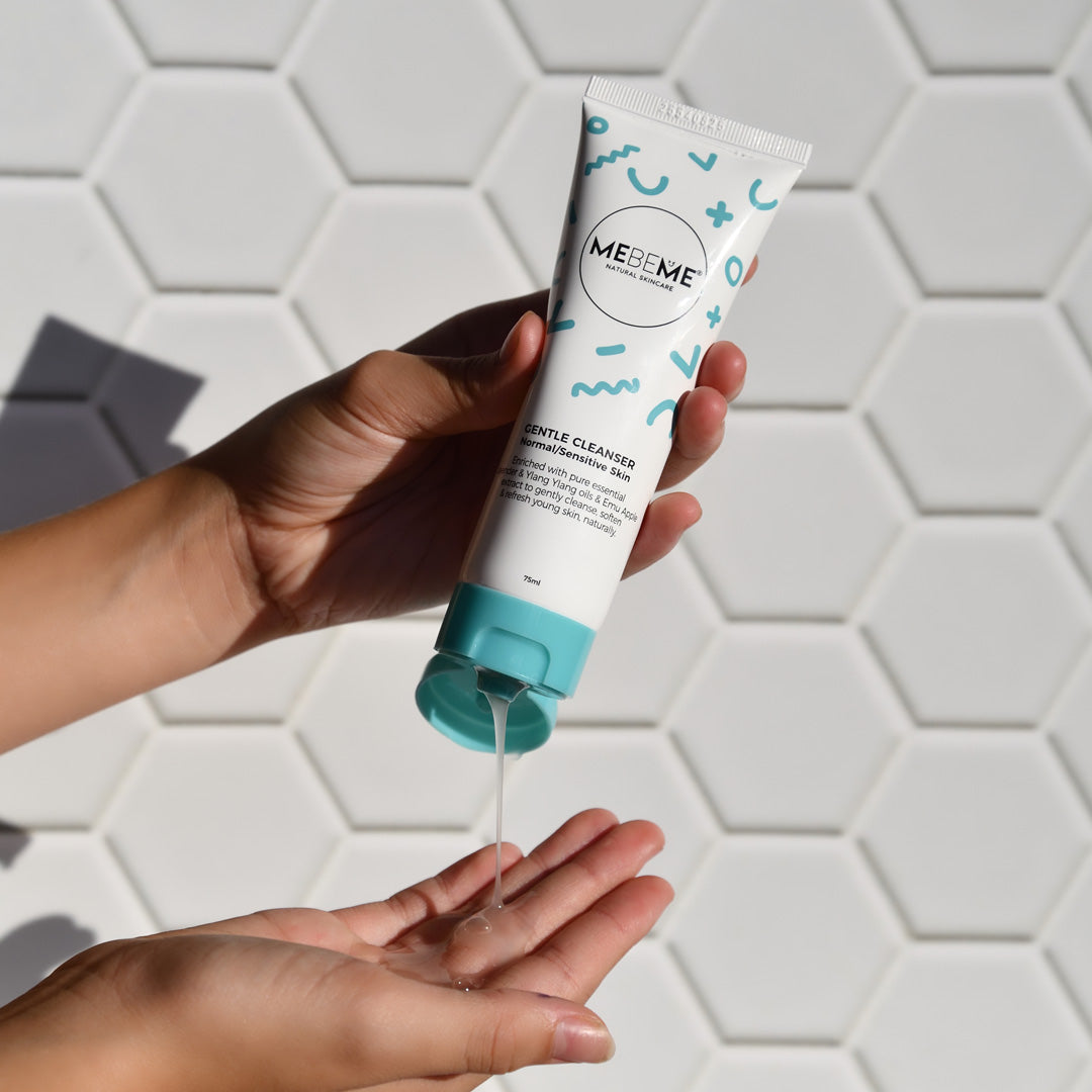 Tube of cleanser squeezed into hand on white hexagonal background