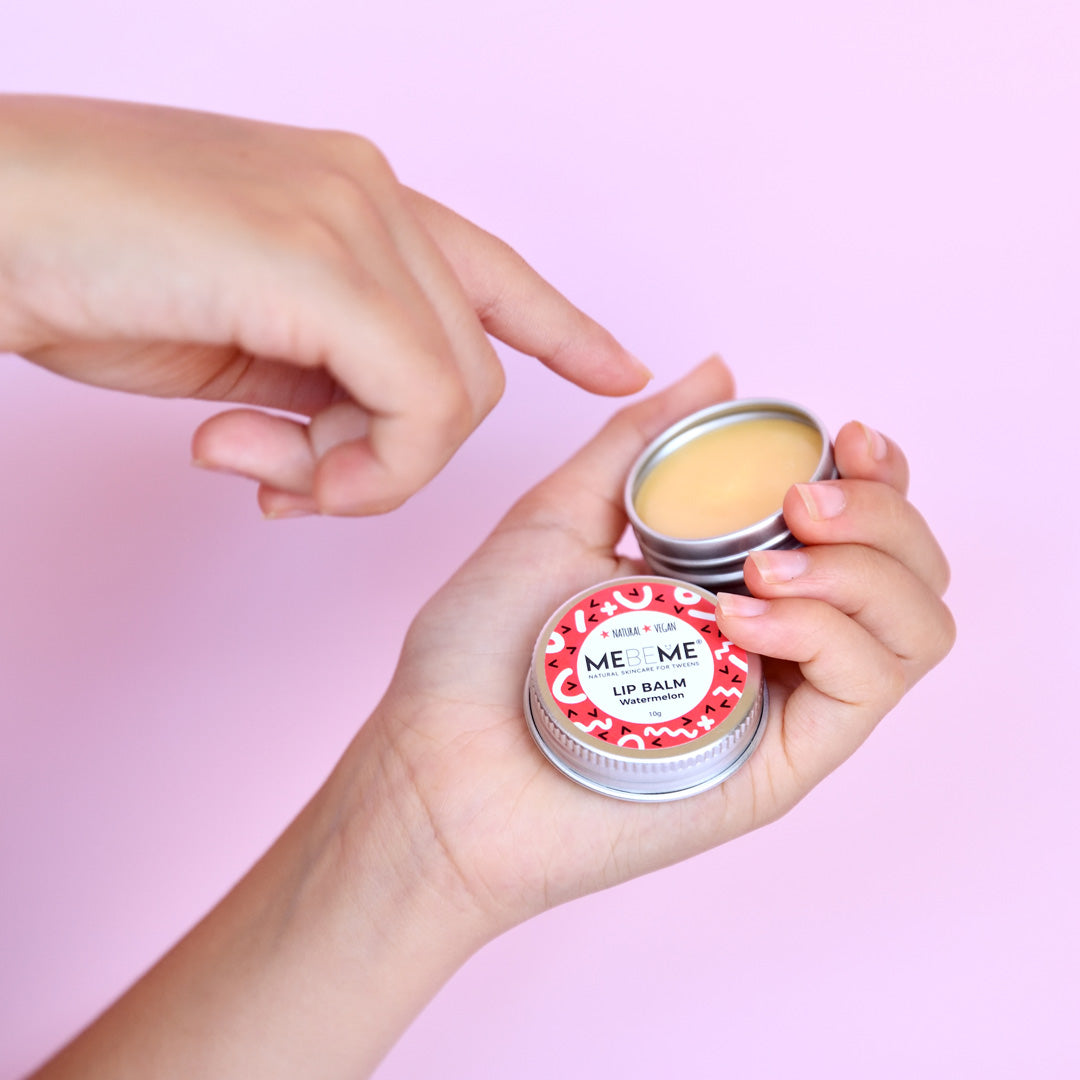 Hands holding open watermelon lip balm