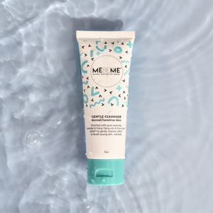 white tube of gentle cleanser for normal, sensitive and dry skin, with blue and black squiggles and a blue lid. The tube is lying in water on a blue background.